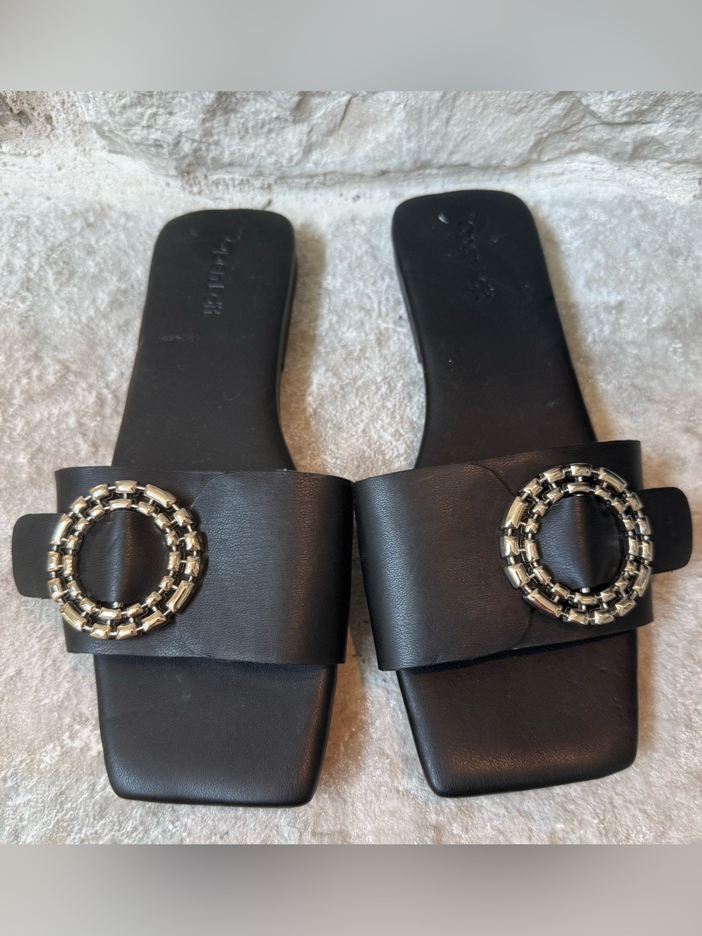 Brand New Open Edit Black Leather Slide Sandals with Silver Buckle Accent.
